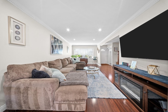 living room with wood finished floors, crown molding, recessed lighting, and baseboards