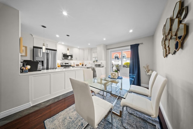 dining space featuring dark wood-type flooring, baseboards, and recessed lighting