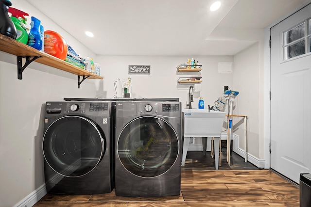 laundry area with independent washer and dryer, recessed lighting, wood finished floors, and baseboards