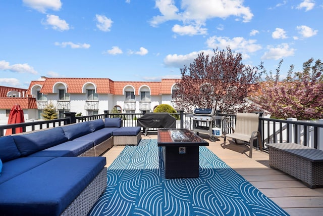 deck featuring an outdoor living space with a fire pit and grilling area