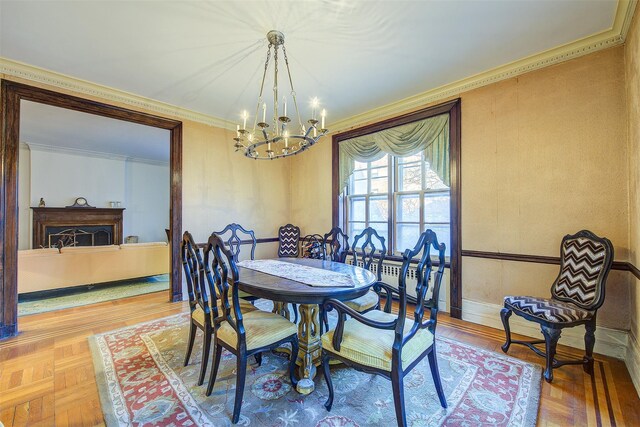 34-06 81st Unit 42, Jackson Heights, NY 11372 - dining room with ornamental molding, a notable chandelier, a fireplace, and baseboards