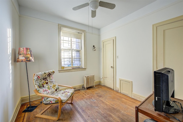 34-06 81st Unit 42, Jackson Heights, NY 11372 - living area with radiator, baseboards, light wood-type flooring, and a ceiling fan