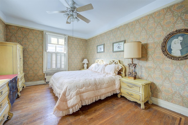 34-06 81st Unit 42, Jackson Heights, NY 11372 - bedroom featuring baseboards, radiator, hardwood / wood-style floors, and wallpapered walls
