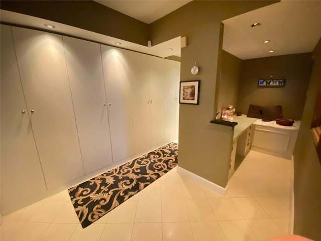 interior space featuring tile patterned flooring, light countertops, and recessed lighting