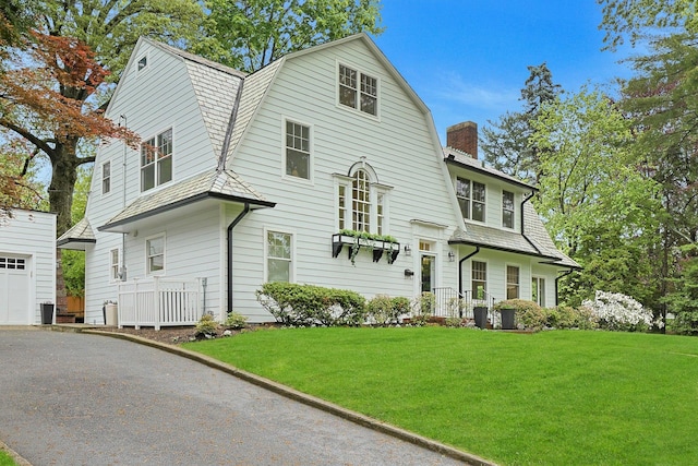 490 Bellwood Ave, Sleepy Hollow, NY 10591 - view of front facade with a gambrel roof, a chimney, a front lawn, and a garage