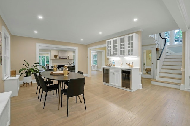 490 Bellwood Ave, Sleepy Hollow, NY 10591 - dining space with beverage cooler, light wood-style flooring, stairs, healthy amount of natural light, and recessed lighting