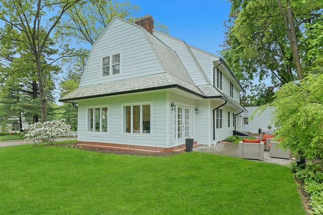 490 Bellwood Ave, Sleepy Hollow, NY 10591 - rear view of house with a lawn, a gambrel roof, a chimney, and a patio area
