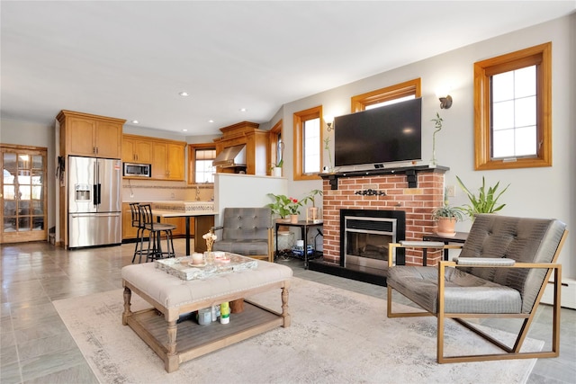 living room with a brick fireplace and recessed lighting