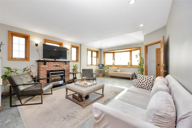 living room with plenty of natural light, a fireplace, and recessed lighting