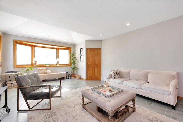 living room with baseboards, a baseboard radiator, and recessed lighting
