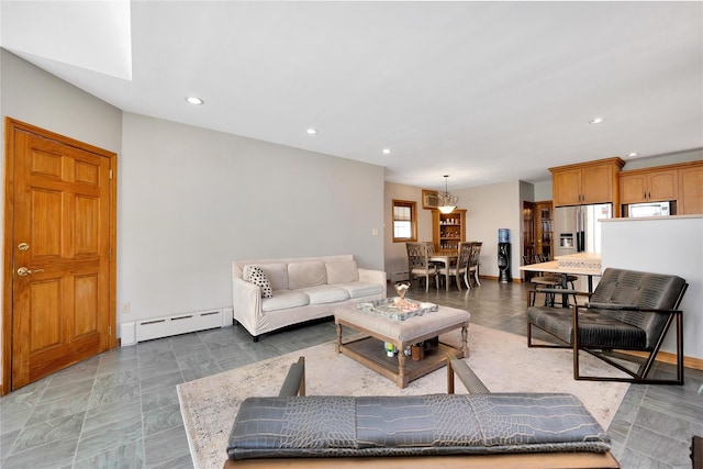 living area featuring a baseboard heating unit and recessed lighting