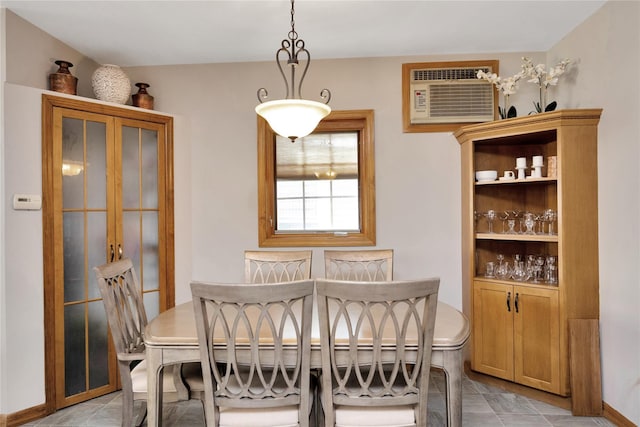 dining space featuring light tile patterned floors and a wall unit AC