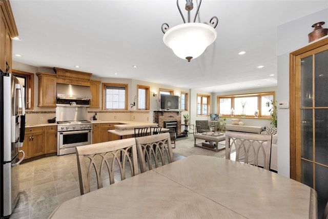 dining space with a brick fireplace and recessed lighting