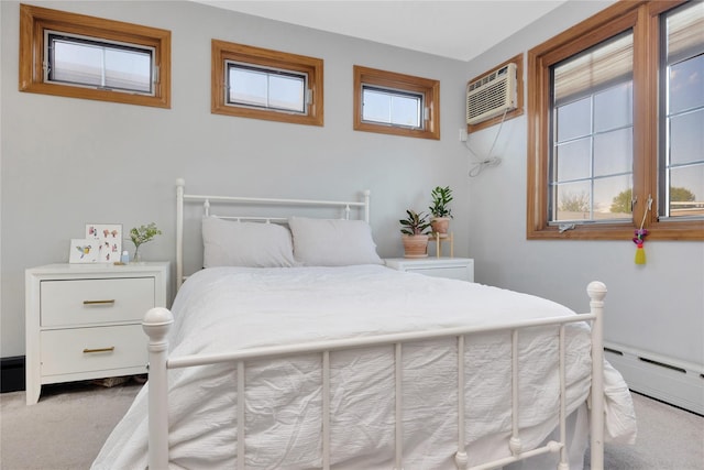bedroom with a baseboard radiator, carpet flooring, and a wall mounted AC