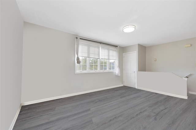 empty room with wood finished floors and baseboards