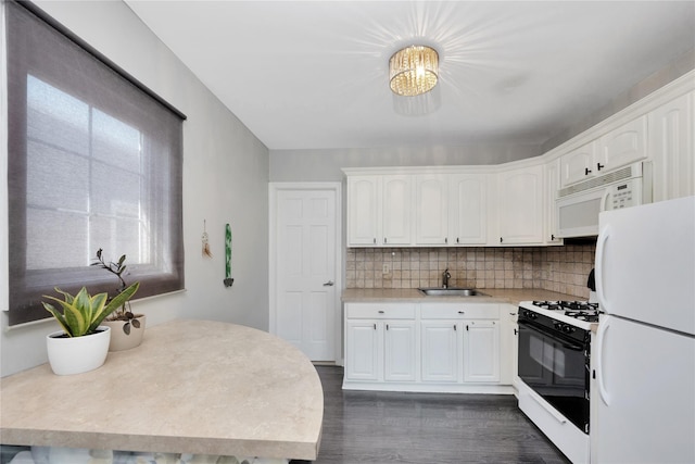 kitchen with a sink, white cabinetry, dark wood-type flooring, white appliances, and light countertops