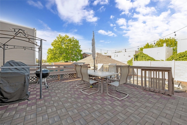 view of patio / terrace featuring fence, outdoor dining space, and grilling area