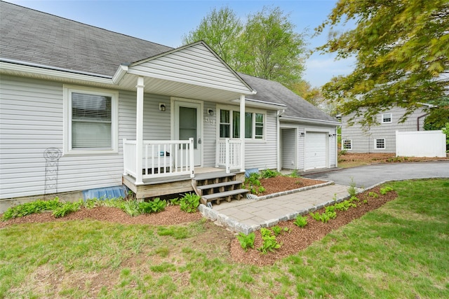 59 Longdale Rd, Mahopac, NY 10541 - view of front of home featuring a shingled roof, an attached garage, driveway, and covered porch