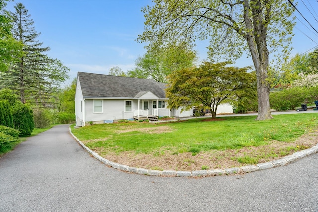 59 Longdale Rd, Mahopac, NY 10541 - cape cod home featuring a front lawn, a porch, and roof with shingles