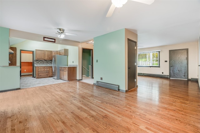 59 Longdale Rd, Mahopac, NY 10541 - unfurnished living room featuring a baseboard radiator, ceiling fan, and light wood-style flooring