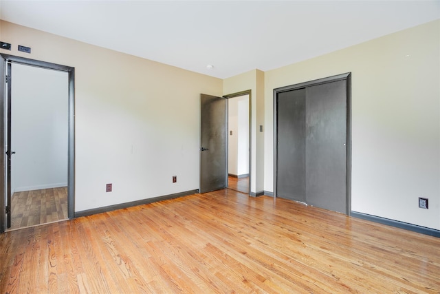 59 Longdale Rd, Mahopac, NY 10541 - unfurnished bedroom featuring wood finished floors, baseboards, and multiple closets