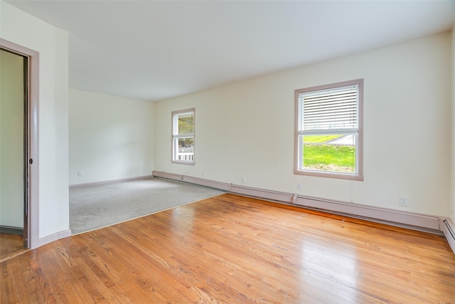 59 Longdale Rd, Mahopac, NY 10541 - spare room with wood finished floors, a baseboard radiator, and baseboards