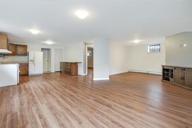 59 Longdale Rd, Mahopac, NY 10541 - unfurnished living room with baseboard heating, light wood-style floors, baseboards, and a sink