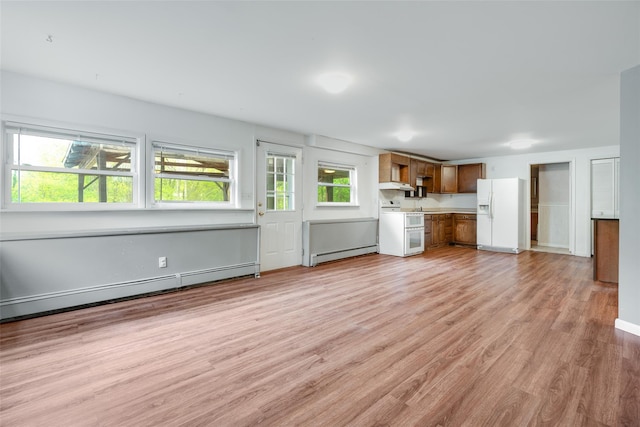 59 Longdale Rd, Mahopac, NY 10541 - unfurnished living room featuring a baseboard heating unit, light wood-style floors, baseboard heating, and baseboards