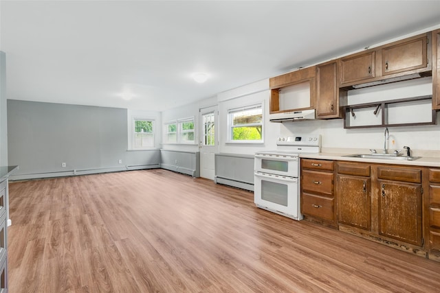59 Longdale Rd, Mahopac, NY 10541 - kitchen with a sink, range with two ovens, baseboard heating, and light wood-type flooring