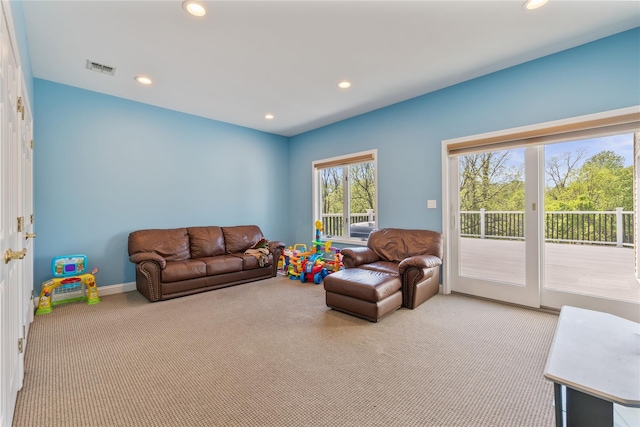 carpeted living room with recessed lighting and baseboards