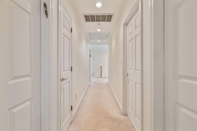 hallway featuring light carpet, baseboards, and recessed lighting