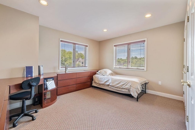 bedroom featuring multiple windows, light colored carpet, a desk, and recessed lighting