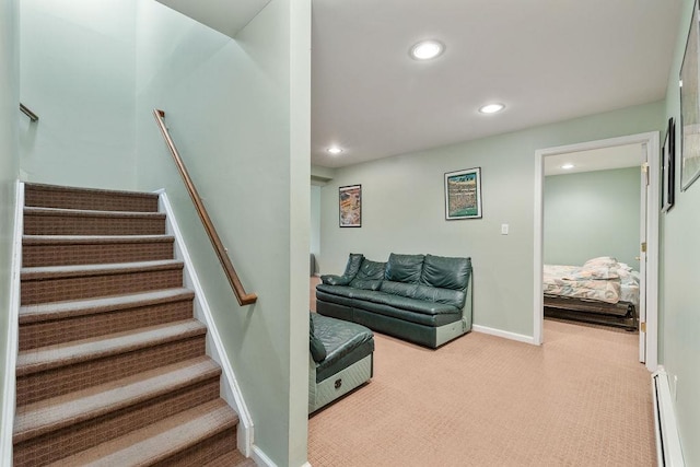 staircase with a baseboard radiator, recessed lighting, carpet flooring, and baseboards