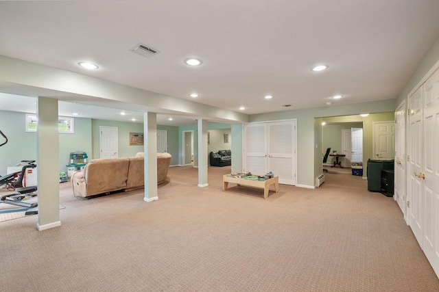finished below grade area with light colored carpet, recessed lighting, and baseboards