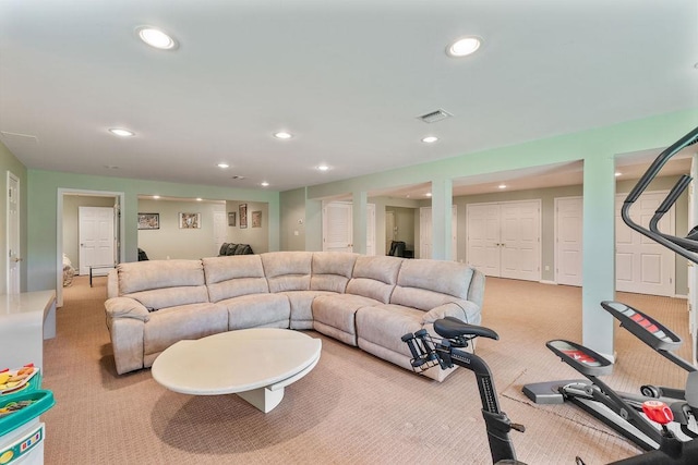living area with light carpet and recessed lighting