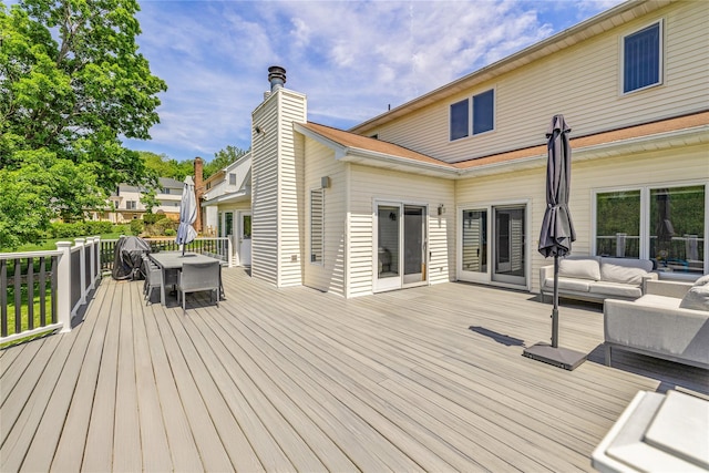 deck with outdoor dining space and an outdoor hangout area