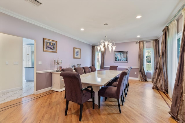 dining space with healthy amount of natural light, crown molding, a chandelier, recessed lighting, and baseboards