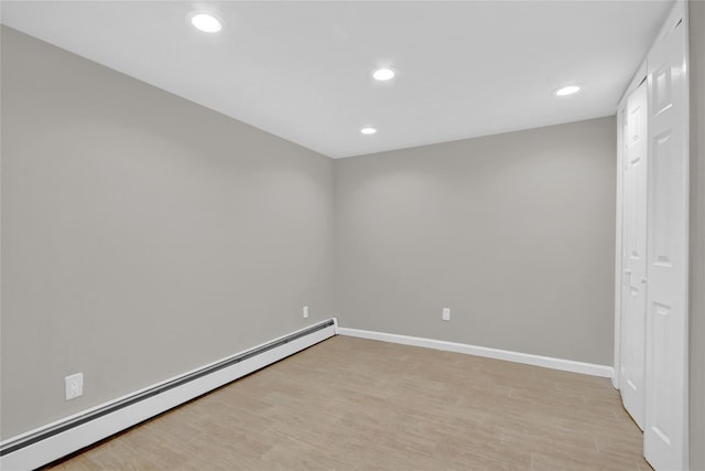 unfurnished room featuring light wood-style floors, recessed lighting, baseboards, and a baseboard heating unit