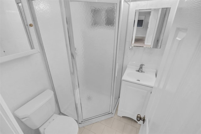 full bathroom featuring tile patterned floors, toilet, a shower stall, and vanity