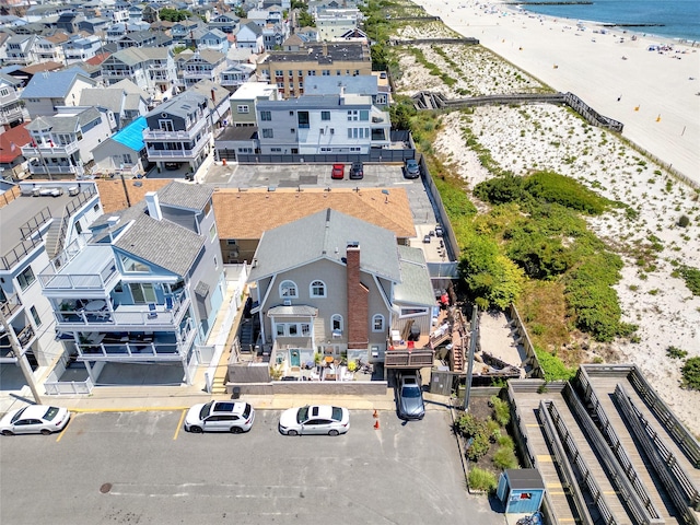 birds eye view of property with a view of the beach and a water view