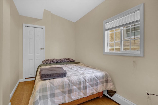 bedroom featuring baseboards, a closet, and wood finished floors