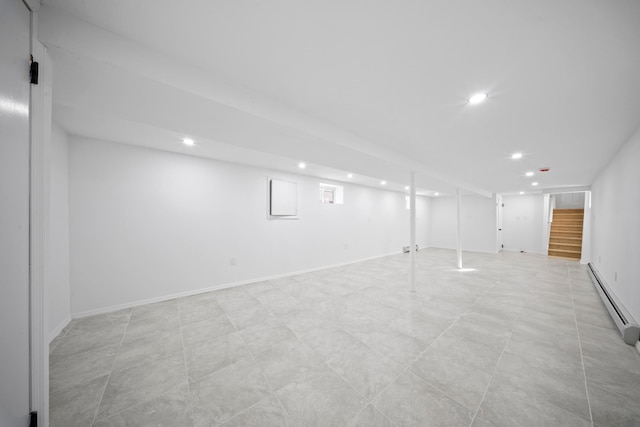 finished below grade area featuring recessed lighting, a baseboard radiator, and stairs