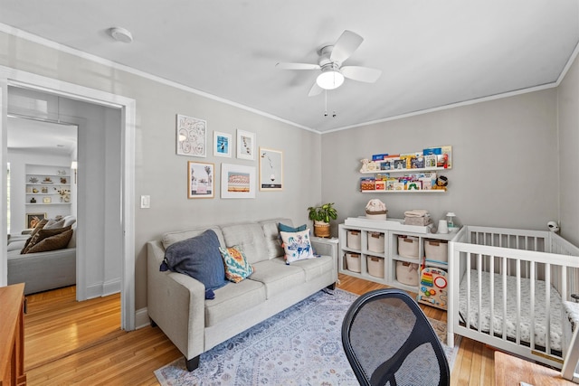 bedroom with wood finished floors, crown molding, and a ceiling fan