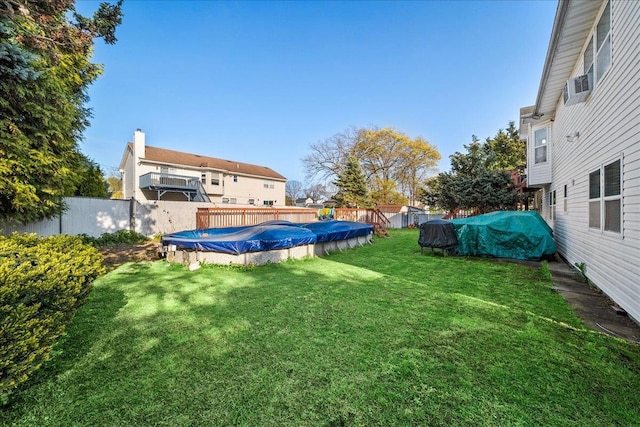 view of yard featuring a fenced backyard, a fenced in pool, and cooling unit