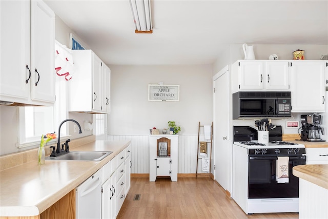 416 W St, Greenport, NY 11944 - kitchen with light countertops, a sink, gas range, dishwasher, and black microwave
