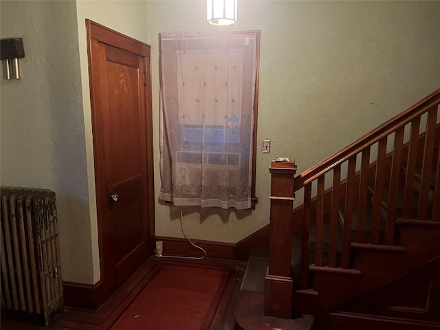 foyer entrance with radiator and stairway