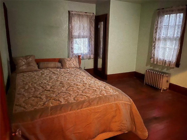 bedroom featuring radiator and baseboards