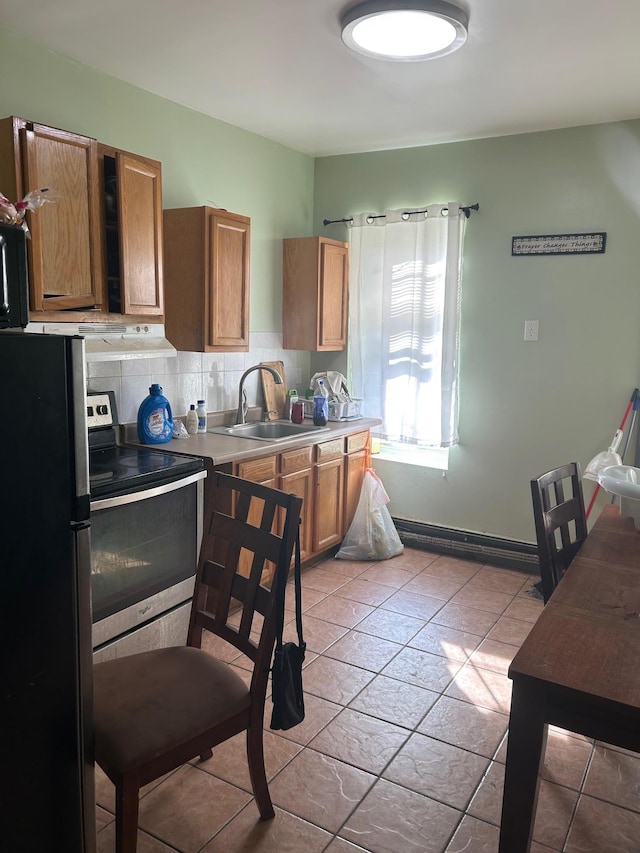 45 S Lander St, Newburgh, NY 12550 - kitchen featuring a sink, brown cabinetry, light countertops, appliances with stainless steel finishes, and tasteful backsplash