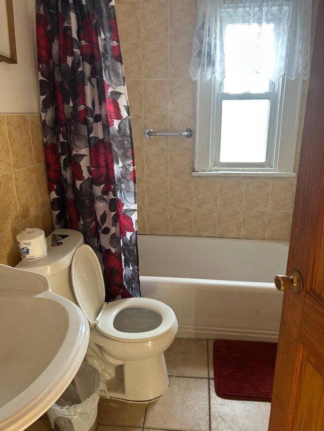 45 S Lander St, Newburgh, NY 12550 - full bath with tile walls, shower / bath combo with shower curtain, toilet, a sink, and tile patterned floors