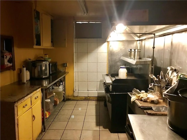 45 S Lander St, Newburgh, NY 12550 - kitchen with light tile patterned floors and stainless steel microwave